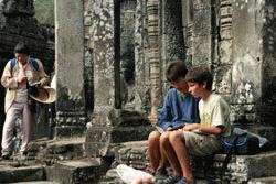 Paul sketches the Bayon complex while Therese watches.