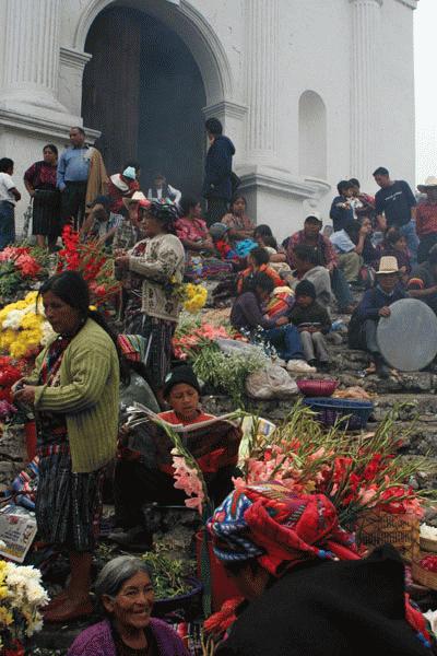 Mayan women peddle flowers on the steps of Igelsia Santos Tomos.