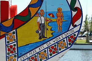 This fisherman sights a trophy catch in a painting on a canal boat in Aveiro