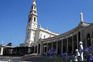 Statues of the three children are in the foreground to the church in Fatima