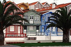 Houses along the Costa Nova beach resort maintain their traditional exterior patterns and colors.