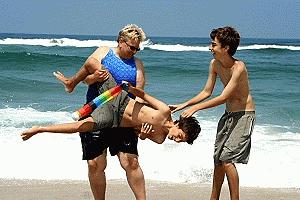 Kathy sends Paul into the surf at Costa Nova, while Peter cheers her on.