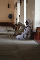 A sister from the Sisters of Charity takes a moment to pray.