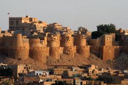 The fort, which springs out of the desert, is surrounded by honey colored buildings of this small town.