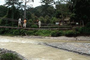 Peter and Paul walk over the Sungai Bohorok to our guest house. This was the river that flooded.