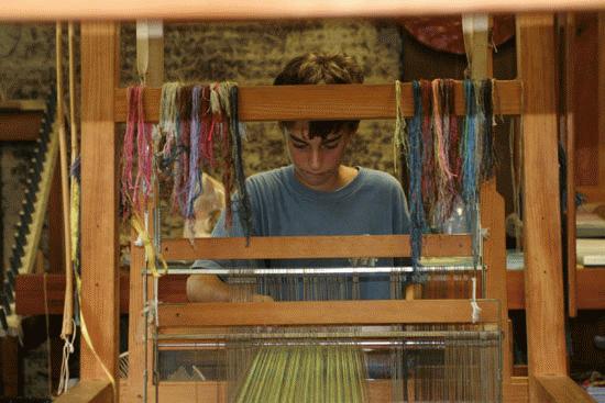 Peter utilizes a loom to create a work of art