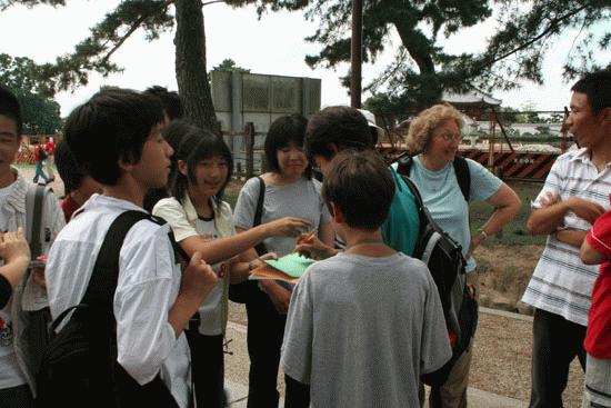 Therese gets interviewed by high school girls for Tokyo while visitng the sitting Buddha temples of Nara.