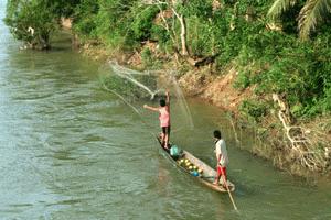 Throw net fishing along the river outside of Vang Vieng