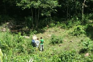 Therese, Paul and Byron (an Aussie zoologist) investigate elephant tracks near a natural salt lick next to the elevated hide.