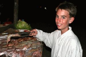 Peter displays the nightly BBQ items of Tiger Prawns, Marlin, Tuna and King Fish. Life if a Beach!