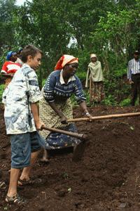 Peter, support field staff, pitches in with the hard work of digging.