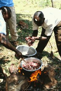 Julius cooks the goat that was slaughtered only minutes ago in celebration of Paul's birthday... a Maasai tradition.