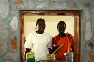 Sereya and Janet prepare a feast for Paul's birthday party, while the goat cooks outside.