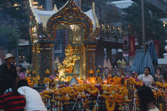 Near Siam Square in Bangkok, music and incense fill the air as throngs of people spend a few minutes praying.