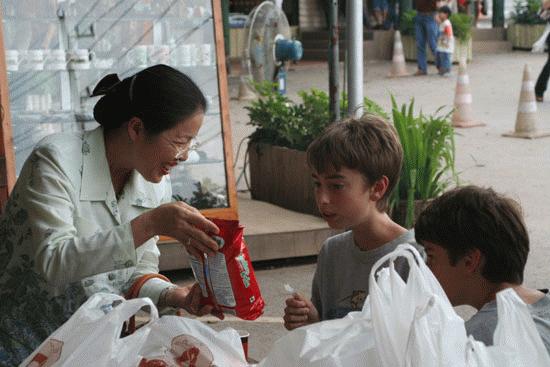 Ton's mom, Noy, provides Peter and Paul some delicious goodies from Umm! dairy in Pok Chang.