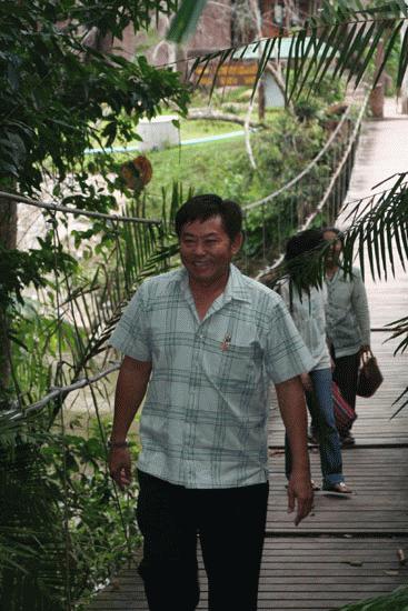 Heng smiles as he follows Peter on a trip to a waterfall in Khao Yai