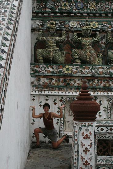 Therese imitates the powerful Wat Arun warrior sculptures