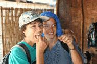 Therese and Veronica sample silk worms with a smile