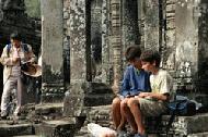 Paul sketches the Bayon complex while Therese watches.