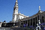 Statues of the three children are in the foreground to the church in Fatima