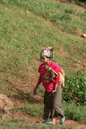 This young Akha woman, carrying her baby, still wears the traditional headdress.