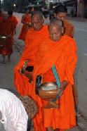 Carrol provides the Buddist monks with sticky rice in the early morning hours