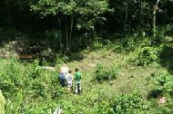 Therese, Paul and Byron (an Aussie zoologist) investigate elephant tracks near a natural salt lick next to the elevated hide.