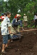 Peter, support field staff, pitches in with the hard work of digging.