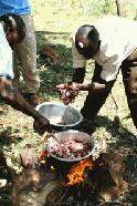 Julius cooks the goat that was slaughtered only minutes ago in celebration of Paul's birthday... a Maasai tradition.