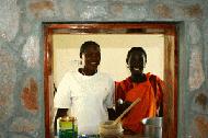 Sereya and Janet prepare a feast for Paul's birthday party, while the goat cooks outside.