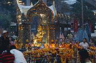 Near Siam Square in Bangkok, music and incense fill the air as throngs of people spend a few minutes praying.