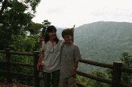 Faang and Paul overlooking the lush, tropical highland forest of Khao Yai National Park.