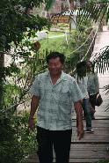 Heng smiles as he follows Peter on a trip to a waterfall in Khao Yai